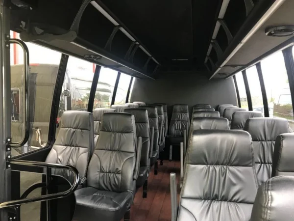 inside of 24 passenger white shuttle bus in louisiana for rent